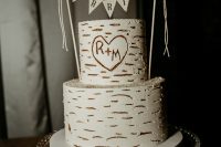 07 The wedding cake was imitating birch bark for a rustic touch and was topped with a banner