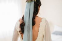 07 a lace sheath wedding dress with a cutout back and a floral headpiece with a powder blue veil to add a bit of color