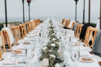 08 The wedding tablescape was done with white blooms, greenery and candles – simple and very elegant