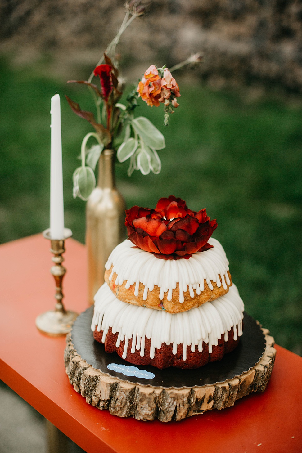 There was a large bundt wedding cake with glazing and a bloom on top