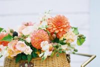 09 This basket floral arrangement is real essence of summer, with bright and blush blooms, leaves and berries