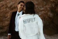 10 The bride covered up with a white jacket with tassels, macrame and sequin letters