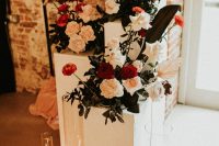 11 A wedding altar in white, with white and red blooms and black and white candles