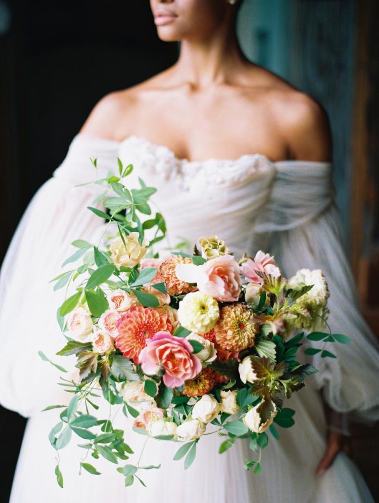 Her wedding bouquet was done with lush greenery, much texture and bright blooms