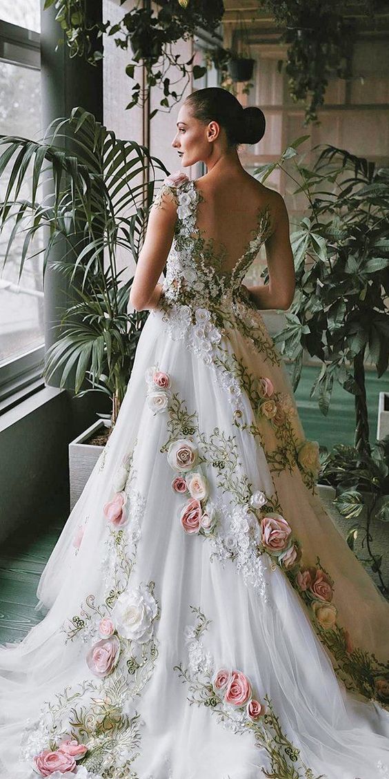a fantastic one shoulder wedding dress in white with embroidery and floral appliques all over the dress