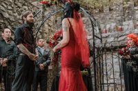 17 a red lace mermaid wedding dress with a train and an open back plus a red veil for a Gothic bride
