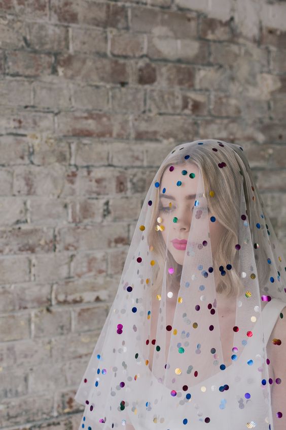 a white veil with colorful polka dots will show your playful mind and your love to colors