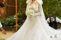 25 an A-line embellished wedding dress with long sleeves, an illusion neckline and a matching veil
