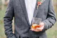 beige pants, a grey tweed jacket, a white shirt plus a greenery boutonniere for a relaxed boho groom’s look