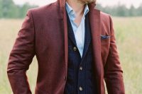 green pants, a blue shirt, a navy cardigan and a red blazer with a navy pocket square for a relaxed boho look