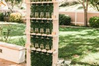 05 a wooden champagne wall with boxwood looks chic and trendy
