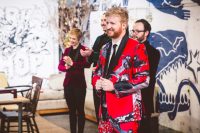 06 The groom’s second look was done with a bold red suit printed with birds and flowers