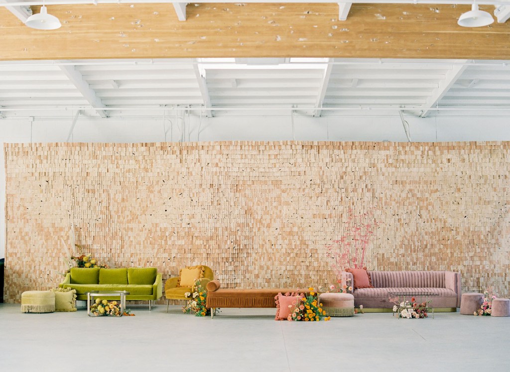 The wedding lounge was done with purple, mustard and rust velvet furniture and bold blooms