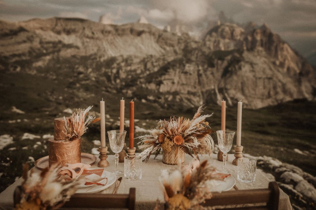 There was a small picnic table done with colroed candles, a dried flower and grass centerpiece and rust napkins and stationery