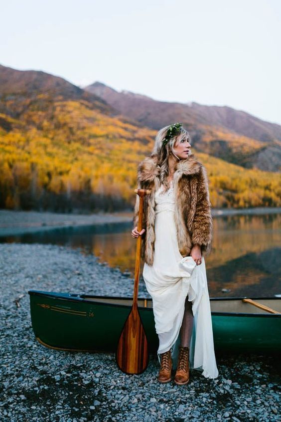 a fur coat and comfy brown boots make the bridal look complete and she feels comfortable outside