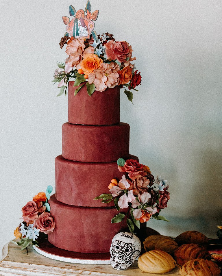 The wedding cake was a matte burgundy one, decorated with bold blooms and there were some traditional cookies served