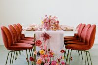 11 The wedding tablescape was done with pink and mustard blooms and a bold floral arrangement at the table