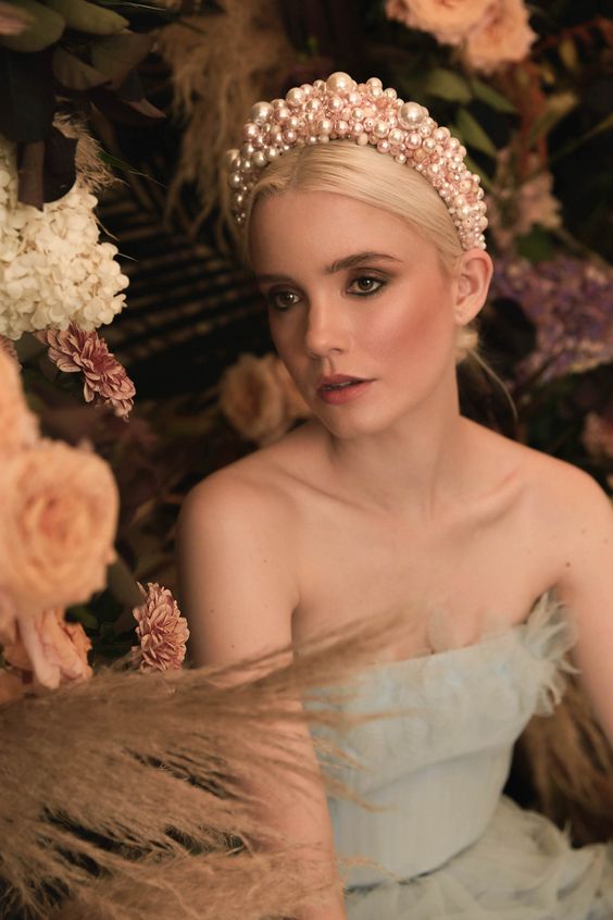 an oversized pink pearl headband is a bold statement in any bridal look and a fresh take on classics
