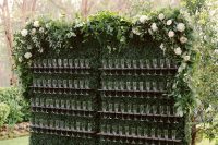 13 a stunning greenery drink wall with foliage and lush blooms on top is a chic idea to rock