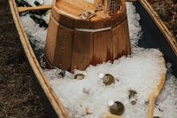 19 a canoe self-service bar with ice, oars, a wooden bucket and plastic cups