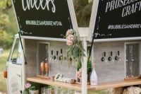 22 a cool car bar with chalkboards, blooms and greenery, usual and copper glasses is adorable