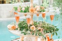 23 a glam stand with greenery and pastel blooms, candles and drinks for a modern glam wedding