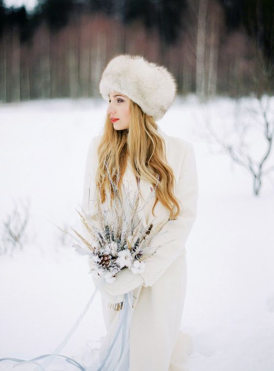 a fur hat and a white long creamy coat will keep you warm and comfortable even outside