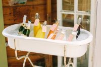 28 a mini tub on a stand with ice and fresh drinks is a simple and cute idea for your wedding
