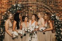 Bridesmaids were dressed in beige V-neck maxi gowns