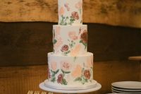 The three tiered wedding cake with floral images was in the same style as all decor details
