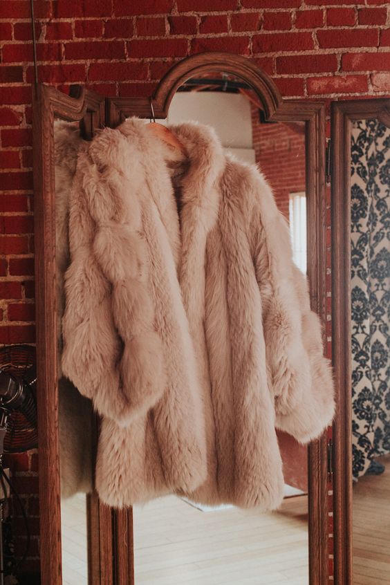 a blush faux fur bridal coat is a cool cover up idea for a fall or winter wedding, it will add a soft touch of color
