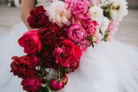 a bold cascading wedding bouquet from white and light pink to pink, red and burgundy is a breathtaking idea