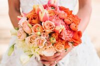 a bright ombre wedding bouquet from white to blush, pink and fiery red blooms looks statement-like