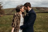 a brown faux fur coat with short sleeves is a pretty addition to a fall or winter bridal look