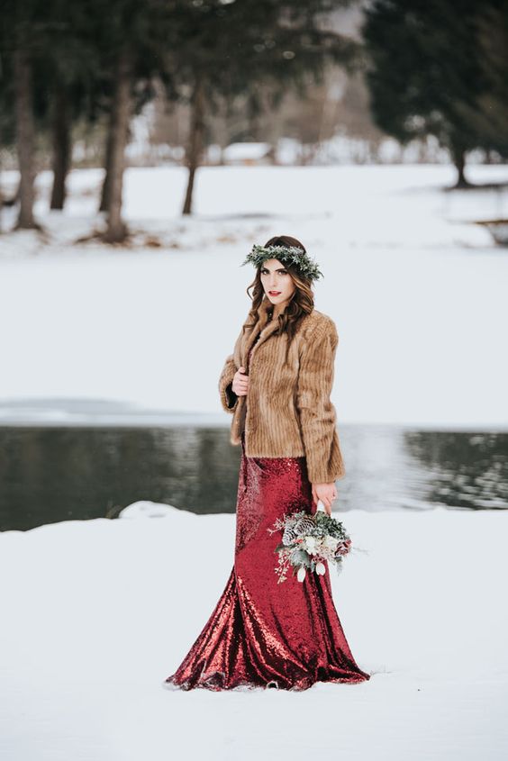 a red sequin wedding dress paired with a briwn faux fur jacket and a flower crown look great together