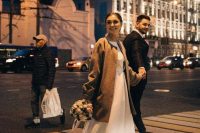 a simple brown midi coat won’t distract attention from your neutral wedding dress