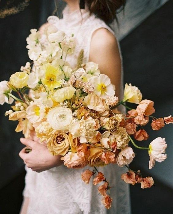 a soft pastel wedding bouquet of white, light and bolder yellow blooms and blush flowers is a chic and refined idea