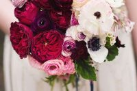 a statement ombre wedding bouquet from pink, red and deep purple to white and with some leaves