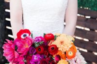 a super bold ombre wedding bouquet of hot pink, pink, blush red, burgundy and orange blooms and of a catchy shape