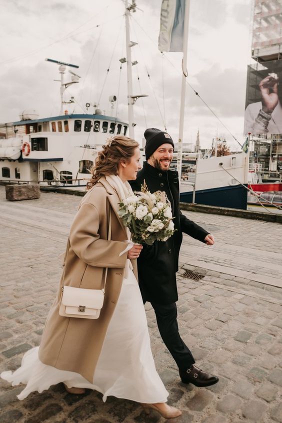 a tan midi coat and tan shoes finish off the bridal look and keep the girl warm enough at the same time