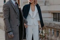 a white pantsuit, a lace bodysuit and a dark green coat on top to feel warm and add a touch of color