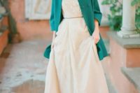 an emerald coat creates a bold accent and highlights the vintage look of the bride