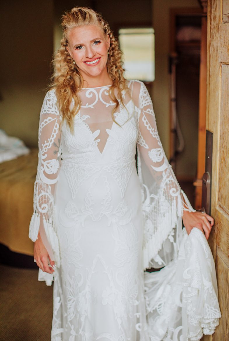 The bride was wearing a boho lace wedding dress with bell sleeves and rocked braided hair