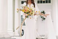 04 The bride was wearing a plain white wedding dress with a plunging neckline and a train plus a veil