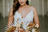 05 Her bouquet was done with blush and rust blooms and fronds and white palm leaves