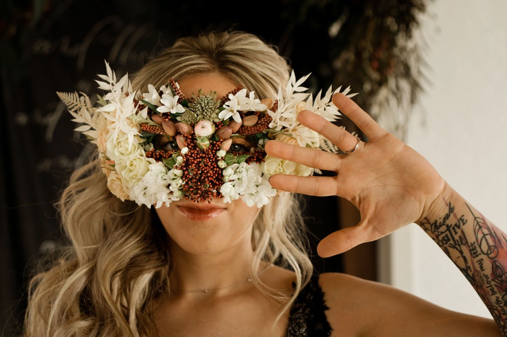 The bride was wearing a gorgeous floral, berry and nut mask that takes breath away