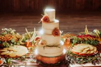 10 The wedding cake was an elegant naked one, topped with rust and blush roses and greenery