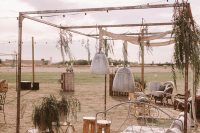 10 The wedding lounge was done neutral, vintage and boho, with a refined daybed, some pendant lamps, burlap and jute rugs, greenery and wooden stools