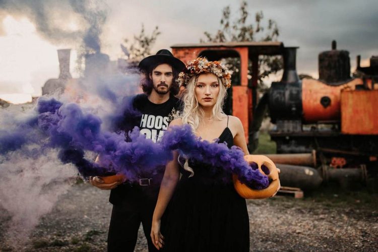 Some carved pumpkins with colorful smoke look amazing in wedding portraits