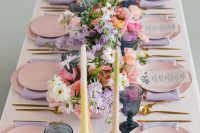 02 The wedding reception space was done in pastels and bold shades, with pink plates, lavender napkins, pastel candles, bright blooms and navy glasses